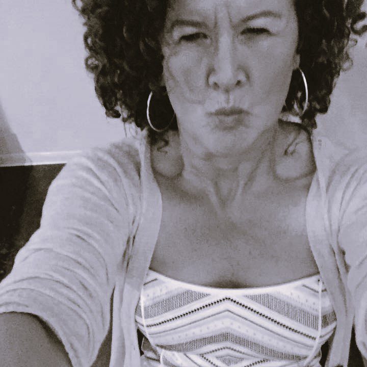 Woman With Curly Hair Making A Kissy Face