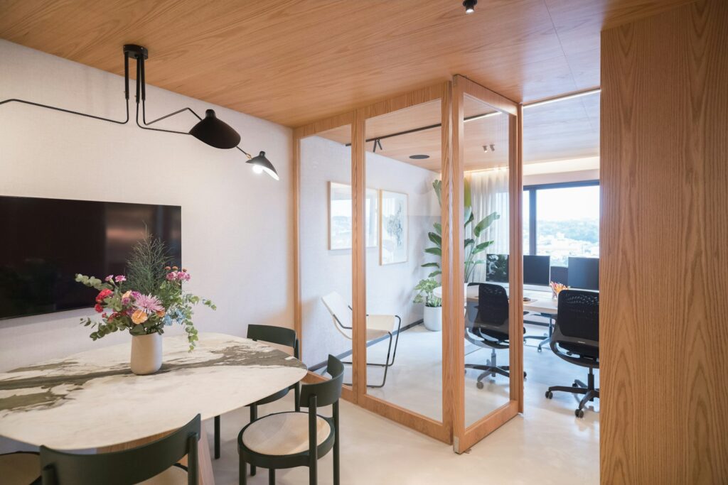 Modern office interior with meeting area and workstations.