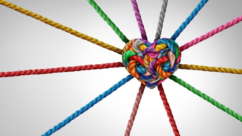 Strength In Connection and Unity of love partnership as diverse ropes shaped as a heart in a group of different intertwined strings connected together shaped as a support symbol of belonging inclusivity or teamwork diversity and togetherness.