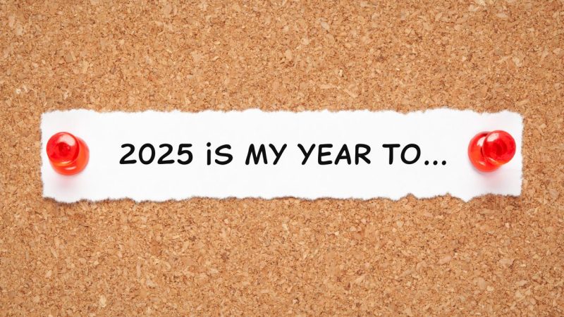 Inspirational New Year 2025 resolutions list concept with headline 2025 is my year to written on a piece of white paper pinned on cork bulletin board.