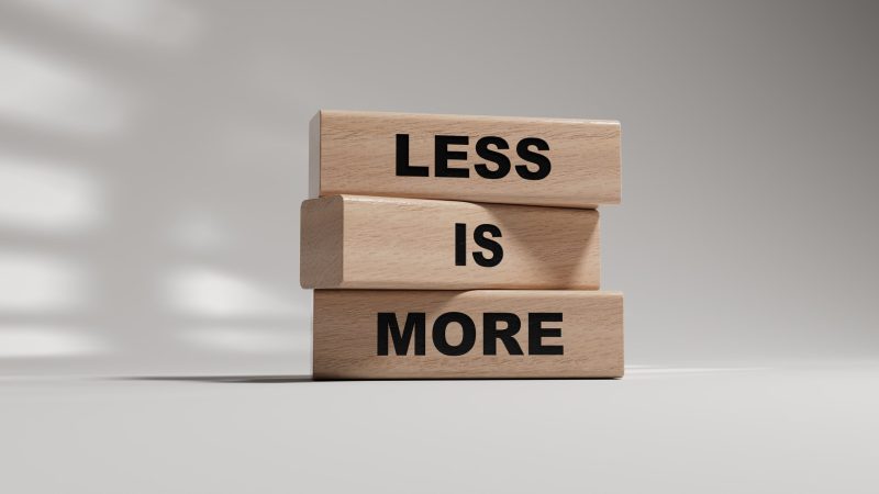 Less is More symbol. Concept words Less is More on wooden blocks. Business and Less is More concept. Copy space.3D rendering on white background.